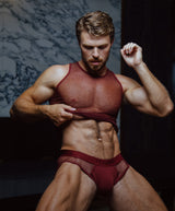Mr. Bradford wears the Teamm8 port Score Sheer tank and brief.