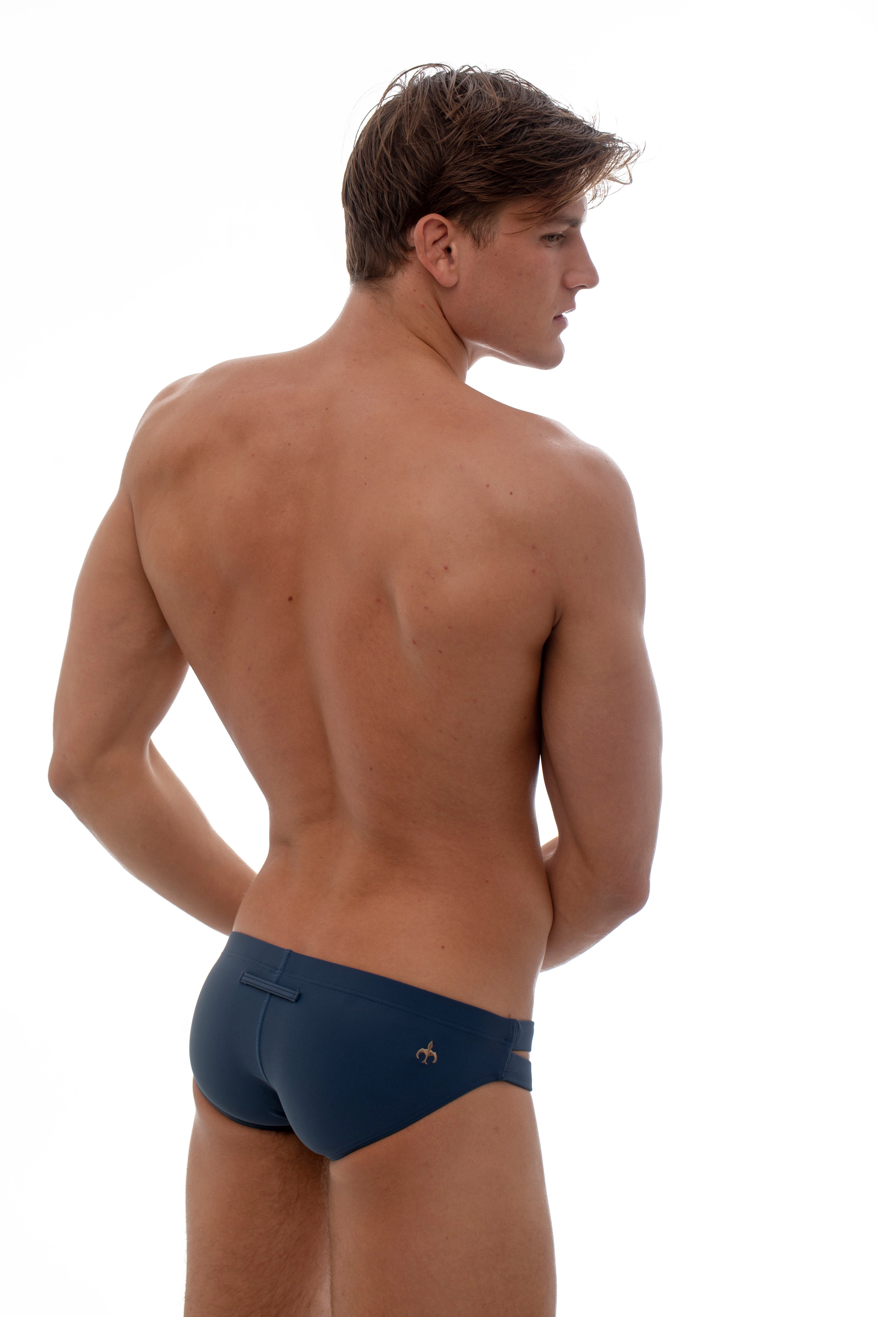 Marcuse bound swim brief in navy with double open straps on the sides.
